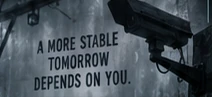 A CCTV camera beside a public propaganda notice.